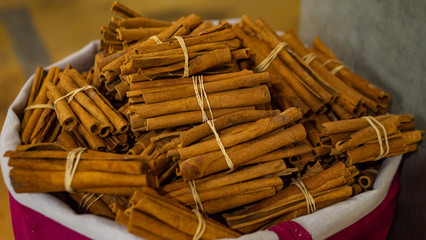 Cinnamon at Moroccan market. Basket full of arabian cinnamon at marketplace close up Marrakech, Morocco