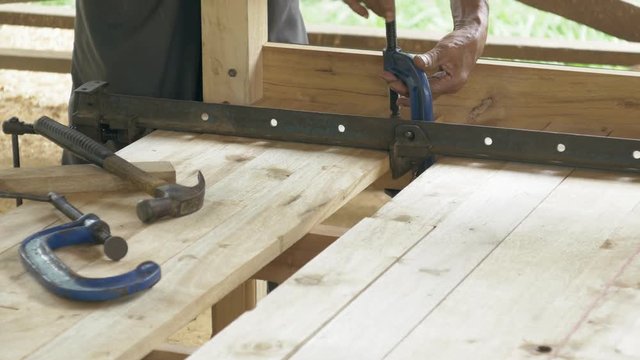 Carpenter making wooden bed.
