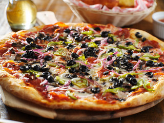 tasty supreme pizza with olives peppers onions and sausage