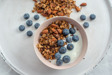 Healthy food background with homemade oatmeal granola or muesli with yogurt and fresh berries