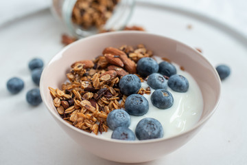Healthy food background with homemade oatmeal granola or muesli with yogurt and fresh berries