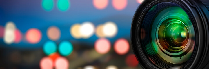 Fototapeta na wymiar Camera lens with reflections on blur background