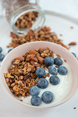 Healthy food background with homemade oatmeal granola or muesli with yogurt and fresh berries