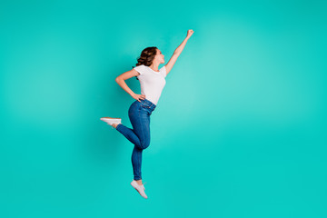 Full length body size profile side view of her she nice-looking attractive cheerful slim fit thin slender wavy-haired lady raising hand up aim isolated on bright vivid shine blue background