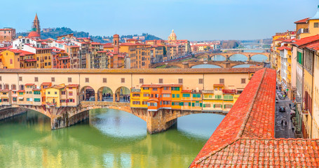Ponte Vecchio over Arno river at bright blue sky - Florence, Italy