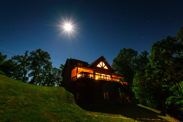 Moonlight over a cabin in the woods