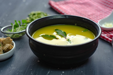 green pea cream soup healthy vegetarian organic food recipe with croutons, garlik and  greens. Homemade traditional meal.