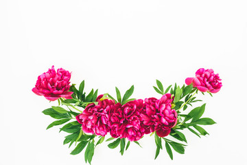 Floral composition made of peony flowers and leaves on white background. Flat lay, top view.