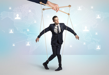 Little businessman controlled from above like a puppet concept
