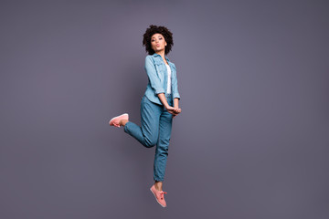 Full length side profile body size photo beautiful she her dark skin lady jump high arms hands...