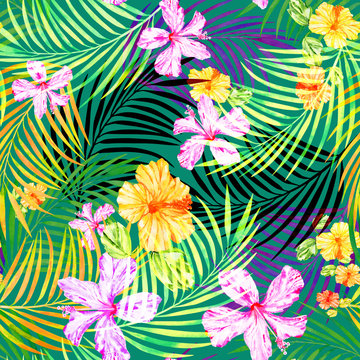 Tropical floral seamless pattern of watercolor palm leaves and hibiscus flowers on a green background.