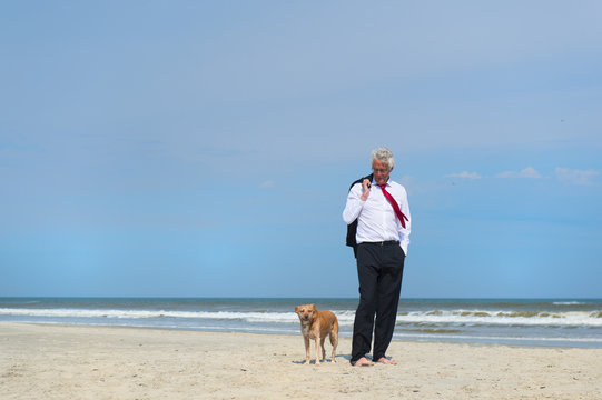 Business Man With Dog At The Beach