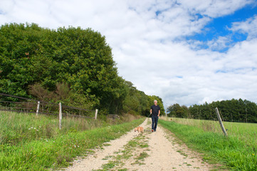 Man walking dog in nature