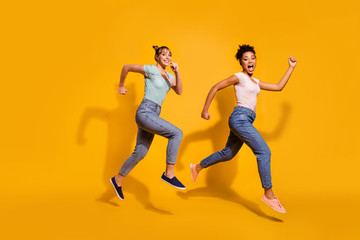 Fototapeta na wymiar Full length body size view photo positive cheerful carefree student free time weekend summer energy race content excited childish curly haircut stylish trendy jeans clothing isolated yellow background
