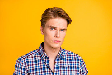 Close-up portrait of his he nice-looking attractive worried nervous guy wearing checked shirt showing shh sign keep dont tell isolated over bright vivid shine yellow background