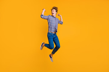 Fototapeta na wymiar Full length body size view portrait of his he nice-looking attractive cheerful cheery optimistic overjoyed guy in checked shirt celebrating isolated over bright vivid shine yellow background