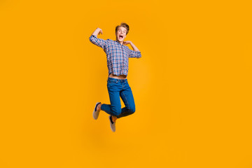 Fototapeta na wymiar Full length body size view portrait of his he nice attractive cheerful cheery optimistic overjoyed guy in checked shirt having fun time isolated over bright vivid shine yellow background