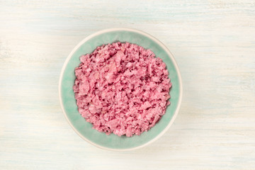 Obraz na płótnie Canvas A bowl of pink Himalayan sea salt, shot from the top