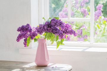 lilac in vase against the window on a sunny day
