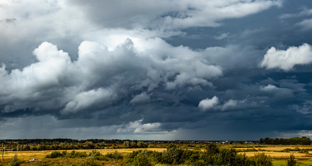 Fototapeta premium Panorama of dramatic stormy clouds over the village