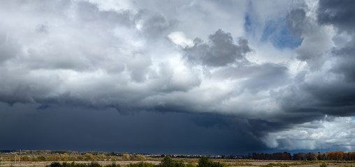 Panorama of dramatic stormy clouds over the village
