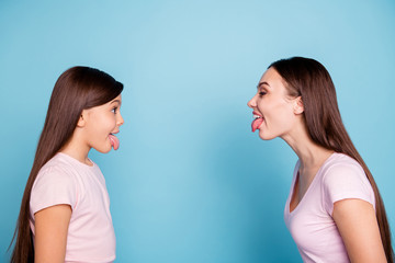 Close-up profile side view portrait of two nice attractive naughty cheerful cheery straight-haired...