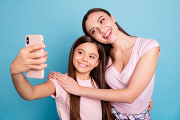 Close-up portrait of two nice cute charming attractive lovely sweet gorgeous cheerful cheery straight-haired girls taking making selfie isolated on bright vivid shine green blue turquoise background