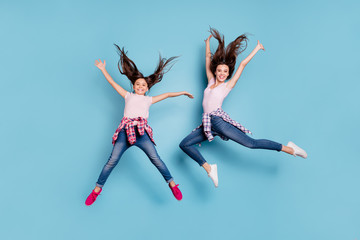 Full length body size view portrait of two nice attractive cheerful cheery careless carefree healthy straight-haired girls having fun rejoicing isolated on bright vivid shine blue turquoise background