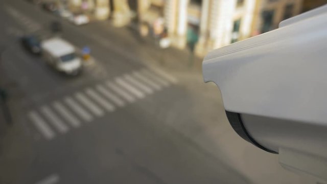 Crime rate in the city and modern video surveillance systems in populated areas. Outdoor CCTV camera with facial and license plates recognition technology. First person view footage