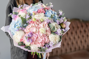 Large Beautiful bouquet of mixed flowers in woman hand. Floral shop concept . Beautiful fresh cut bouquet. Flowers delivery