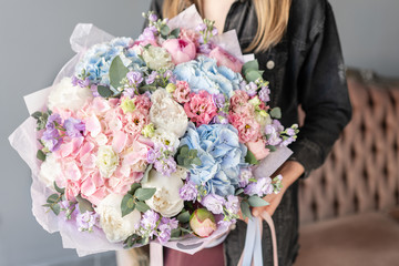Large Beautiful bouquet of mixed flowers in woman hand. Floral shop concept . Beautiful fresh cut...