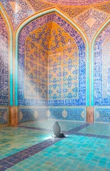 Details of Jameh Mosque - Muslim woman in headscarf and hijab prays in mosque © muratart