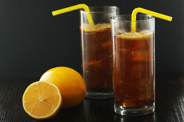 Glasses with cuba libre cocktail or cola with ice or cold tea with lemon