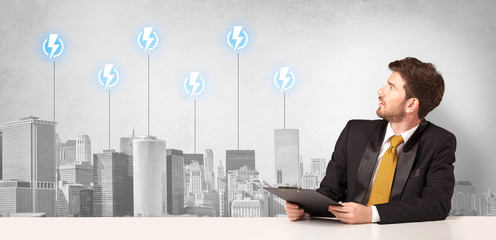 Announcer sitting at desk presenting the city energy consumption
