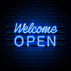 Neon welcome open signboard on the brick wall background.
