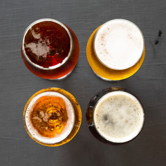 Assorted beers on a black background, top view. Overhead, from above.