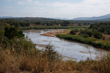 The Black Umfolozi River meandering through the African bush, South Africa.