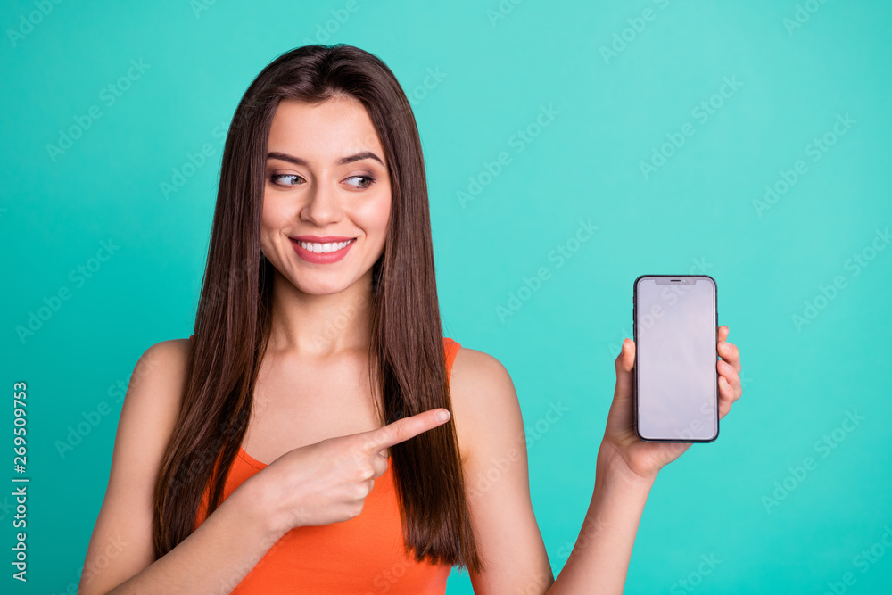 Wall mural Portrait attractive lovely youth have device advertise choose decide feedback demonstrated tip option product promoter beaming cheerful positive satisfied modern clothes isolated turquoise background