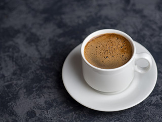 White espresso Cup on dark background with copyspace