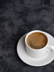 White espresso Cup on dark background with copyspace