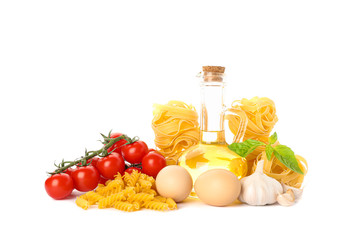 Pasta, olive oil, tomatoes, eggs and garlic isolated on white background. Uncooked whole wheat pasta
