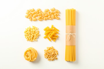 Flat lay composition with different pasta on white background, space for text