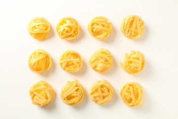 Flat lay composition with different pasta on white background, space for text