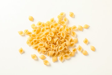 Pasta on white background, space for text. Dry uncooked whole pasta
