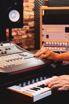 producer hands arranging and mixing music in home studio. music production concept