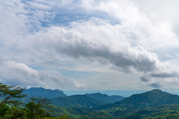Obraz premium Blue sky high peak mountains fog hills mist scenery national park views at Phu Tub Berk, Khao Koh, Phetchabun Province, Thailand