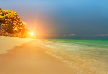 Fantastic deserted beach on the Indian Ocean among the rocks. Paradise vacation.