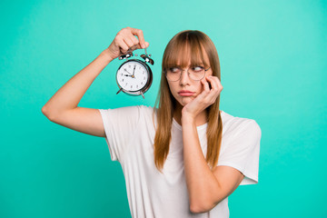 Close up photo amazing beautiful she her lady hold raise arm hand metal alarm clock missed work bad mood afraid to be fired wear specs casual white t-shirt clothes isolated teal green background