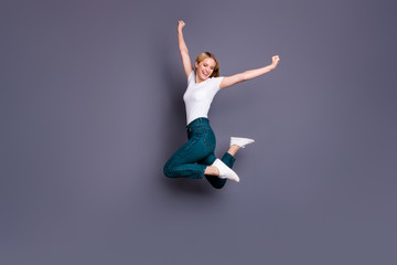 Full length body size view photo of content positive nice lady raise fists scream yeah achieve celebrate aim champion sport fans isolated dressed sneakers clothes grey background