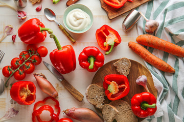 Vegetables, sour cream and bread on table